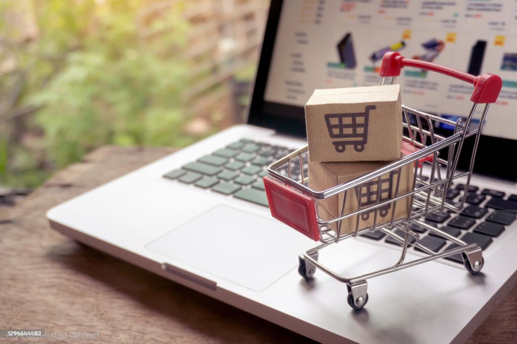 Shopping online concept - Parcel or Paper cartons with a shopping cart logo in a trolley on a laptop keyboard. Shopping service on The online web. offers home delivery.